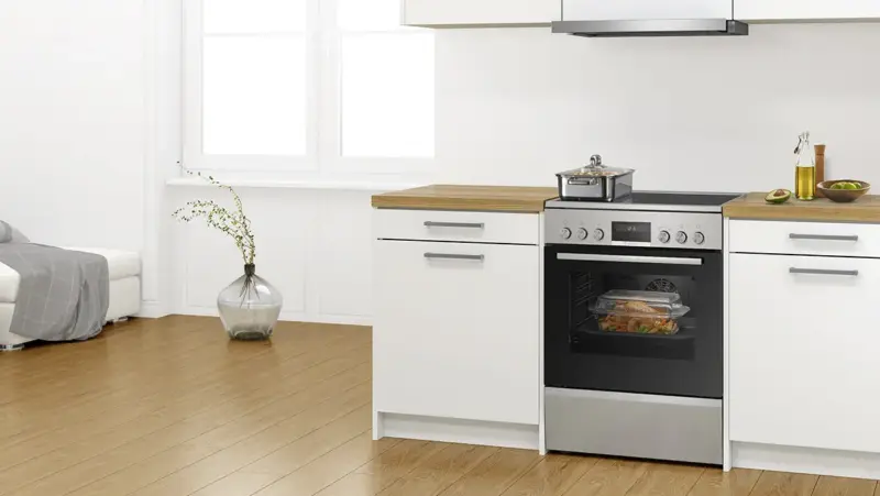 Bosch freestanding cooker in a fitted kitchen with food cooking