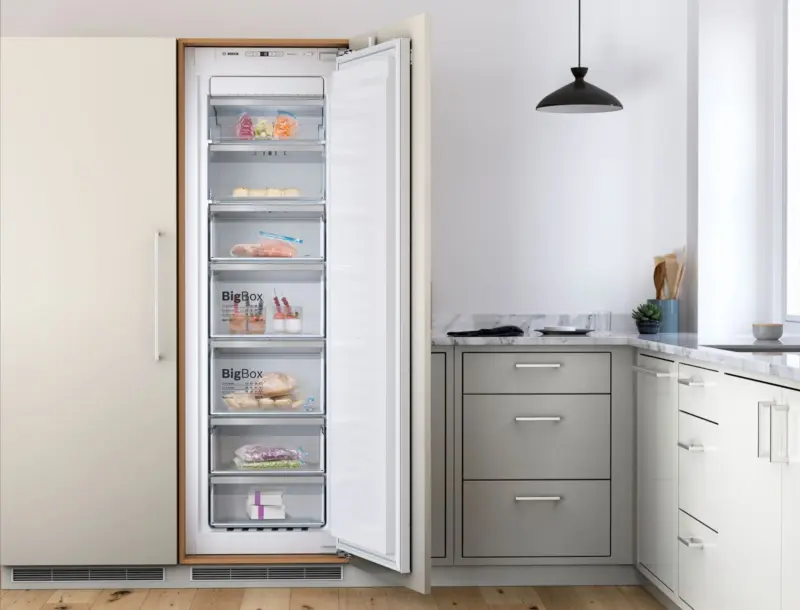 Bosch integrated upright freezer open in a fitted kitchen